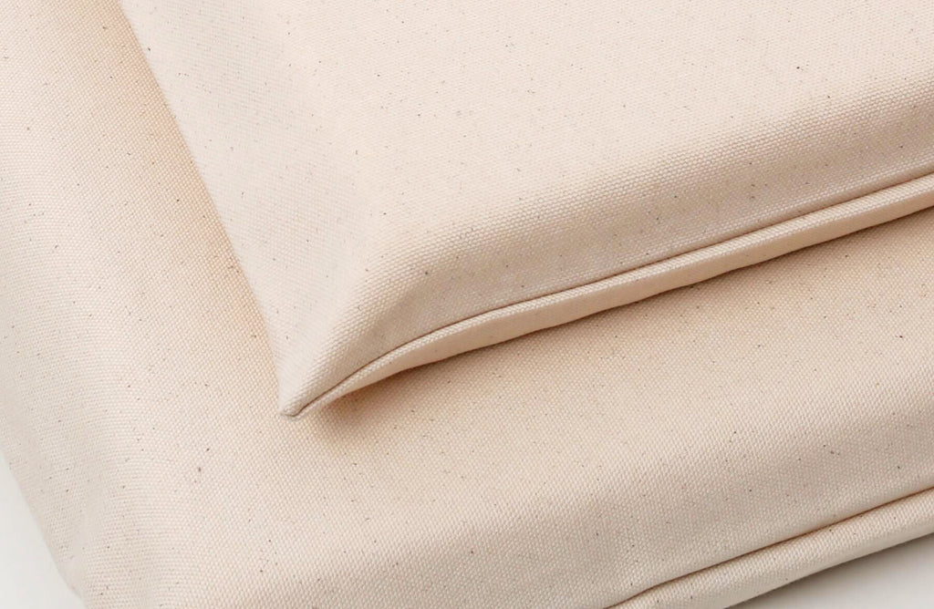 Close up of natural organic canvas fabric on latex dog mat