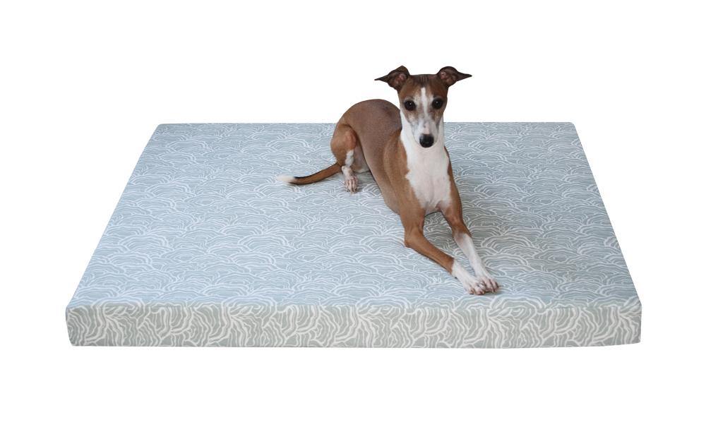 greyhound dog laying on orthopedic dog bed in light blue grey scalloped lichen