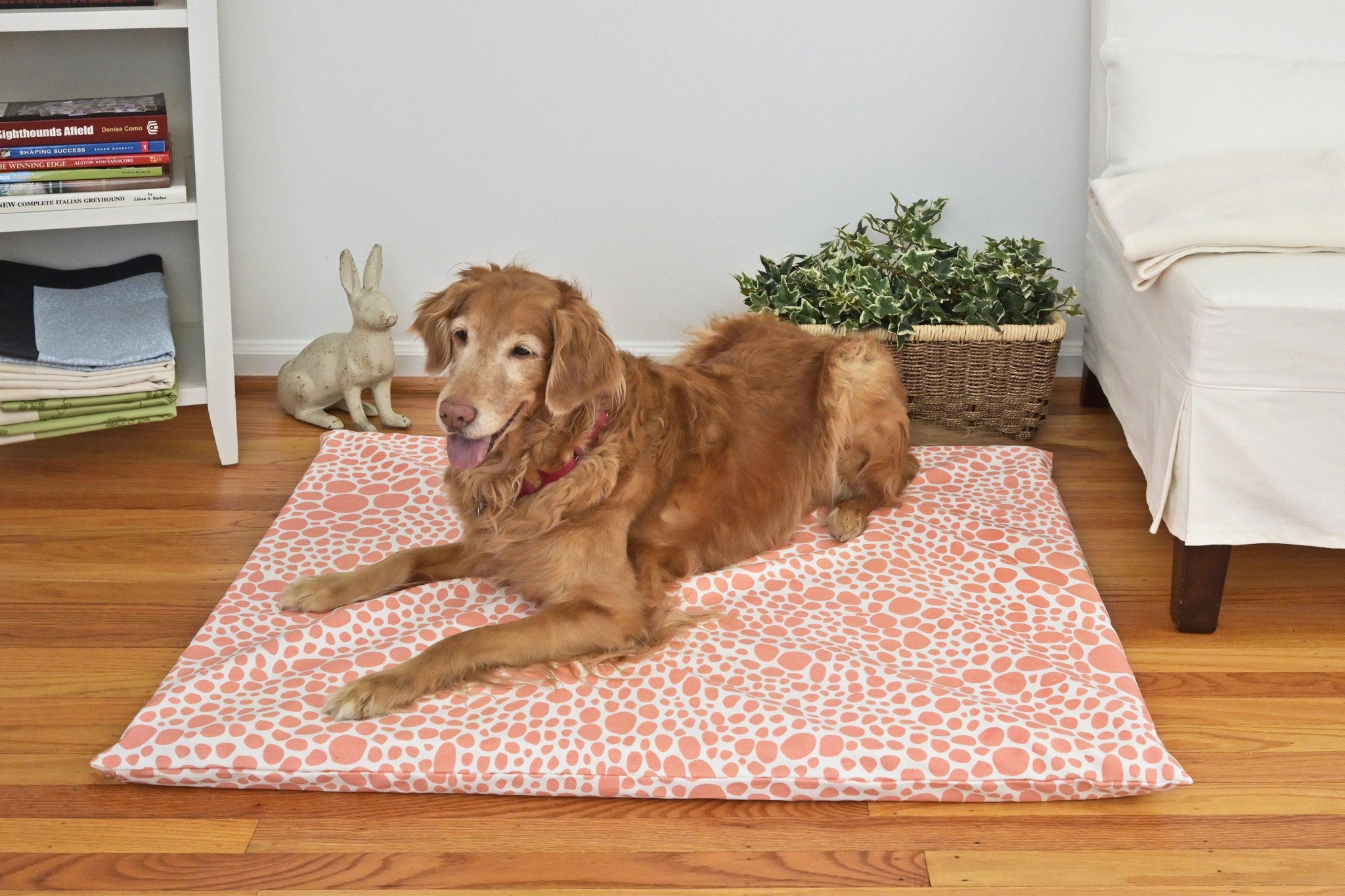 Golden retriever on a coral colored organic dog mat