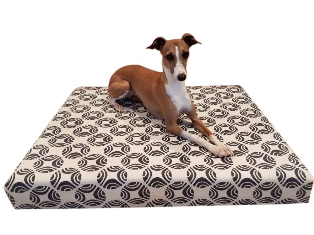 small dog on grey and natural dog bed cover